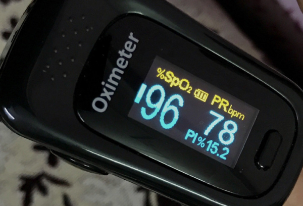 A close up of a health monitoring device called a pulse oximeter